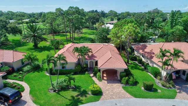 an aerial view of a house with garden space and street view