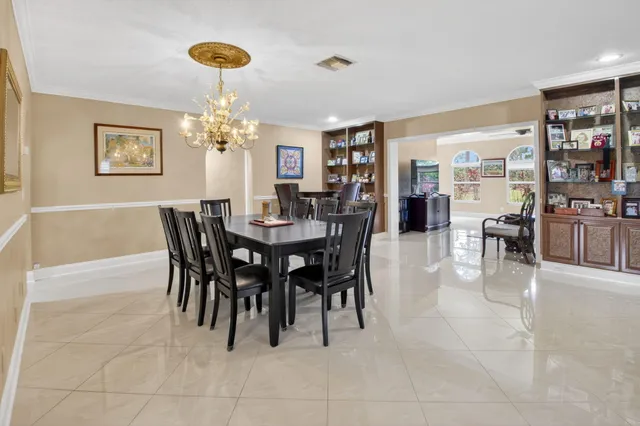 a view of a dining room with furniture and chandelier