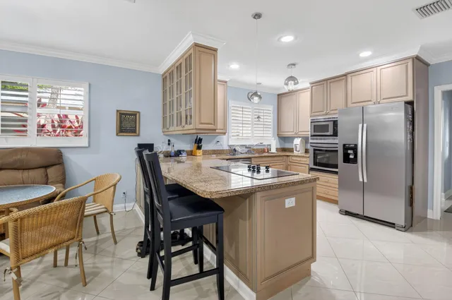 a bathroom with a granite countertop sink a toilet a mirror and shower