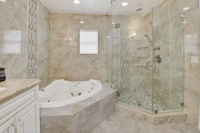 an aerial view of a house with garden space and trees all around