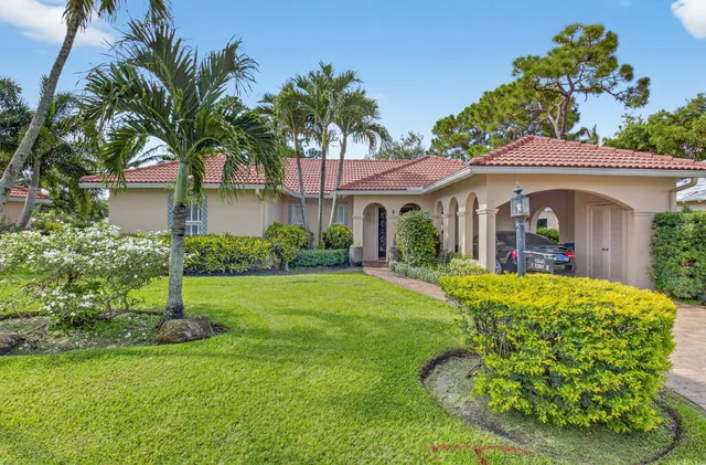 a view of a house with a small yard and a fountain