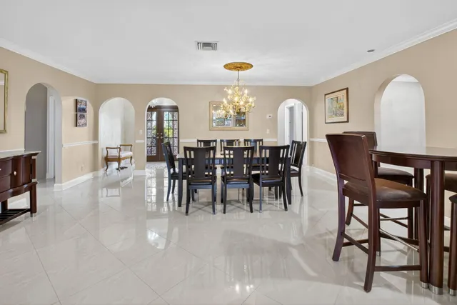 a view of a dining room with furniture and chandelier
