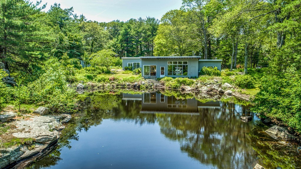 9 Barberry Heights Road Gloucester, MA 01930 - Photo 1 of 1 a view of a lake with a house in the background