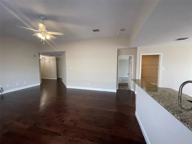 a view of a kitchen with a sink cabinets and wooden floor