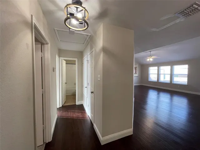 a view of a hallway with wooden floor