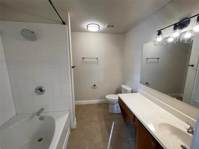a view of a hallway with wooden floor and chandelier
