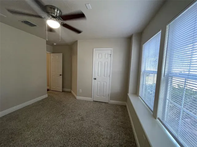 a view of a hallway with closet and wooden floor