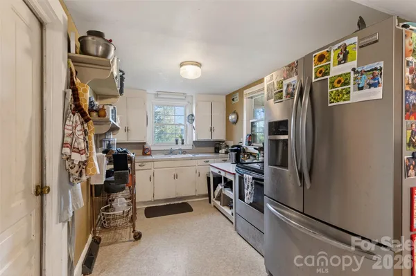a kitchen with a refrigerator and a sink