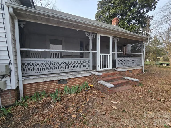 a view of a house with a window and wooden fence