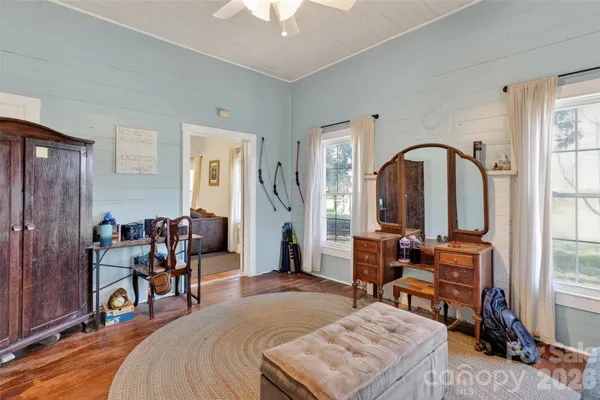 a bedroom with furniture and a window