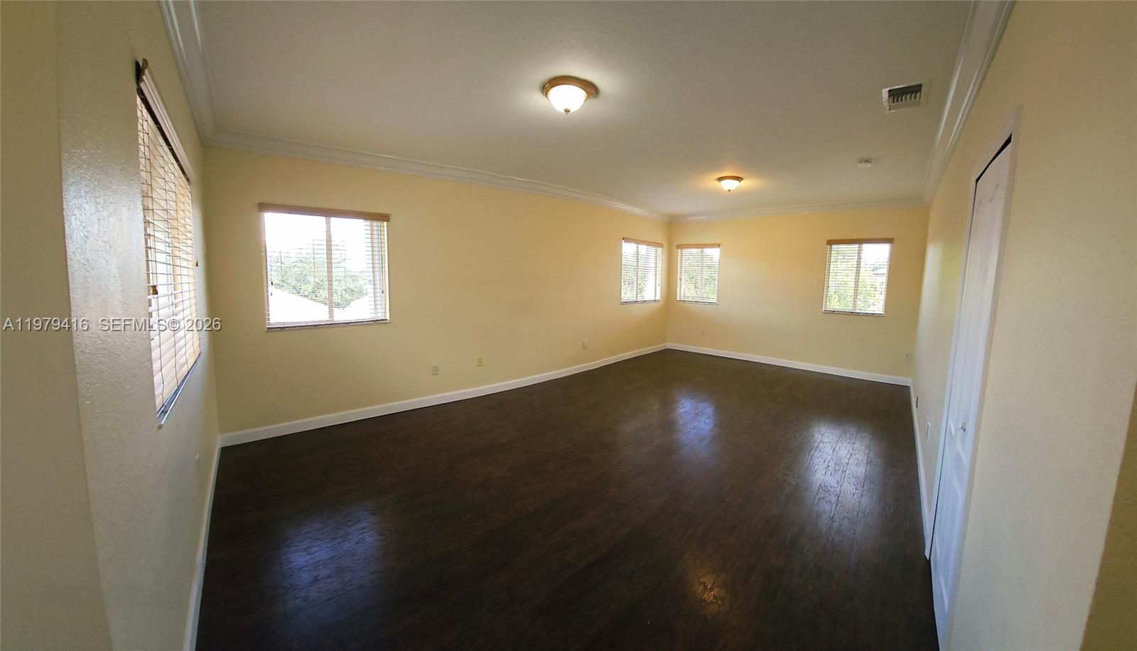 2864 Southwest 138th Path Miami, FL 33175 - Photo 11 of 19 an empty room with wooden floor and windows