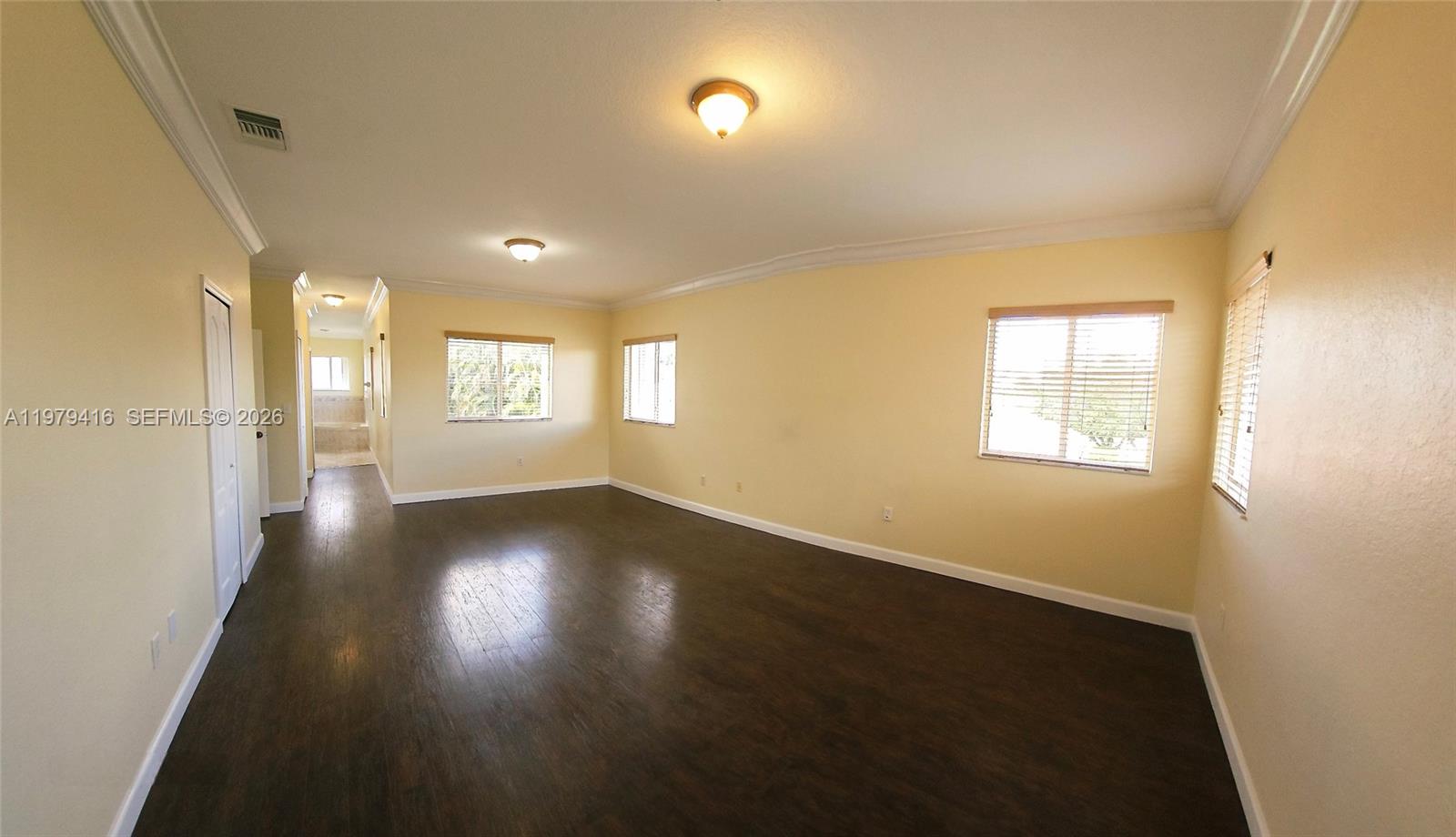 2864 Southwest 138th Path Miami, FL 33175 - Photo 12 of 19 a view of an empty room with wooden floor and a window