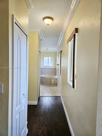 a bathroom with a tub toilet and window