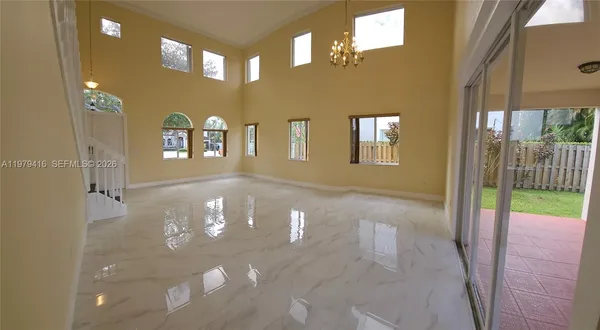 a view of a porch with a dining table chairs