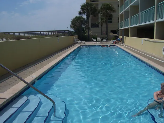 a view of swimming pool with outdoor seating and plants
