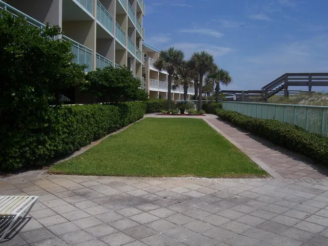 a view of yard with swimming pool and green space