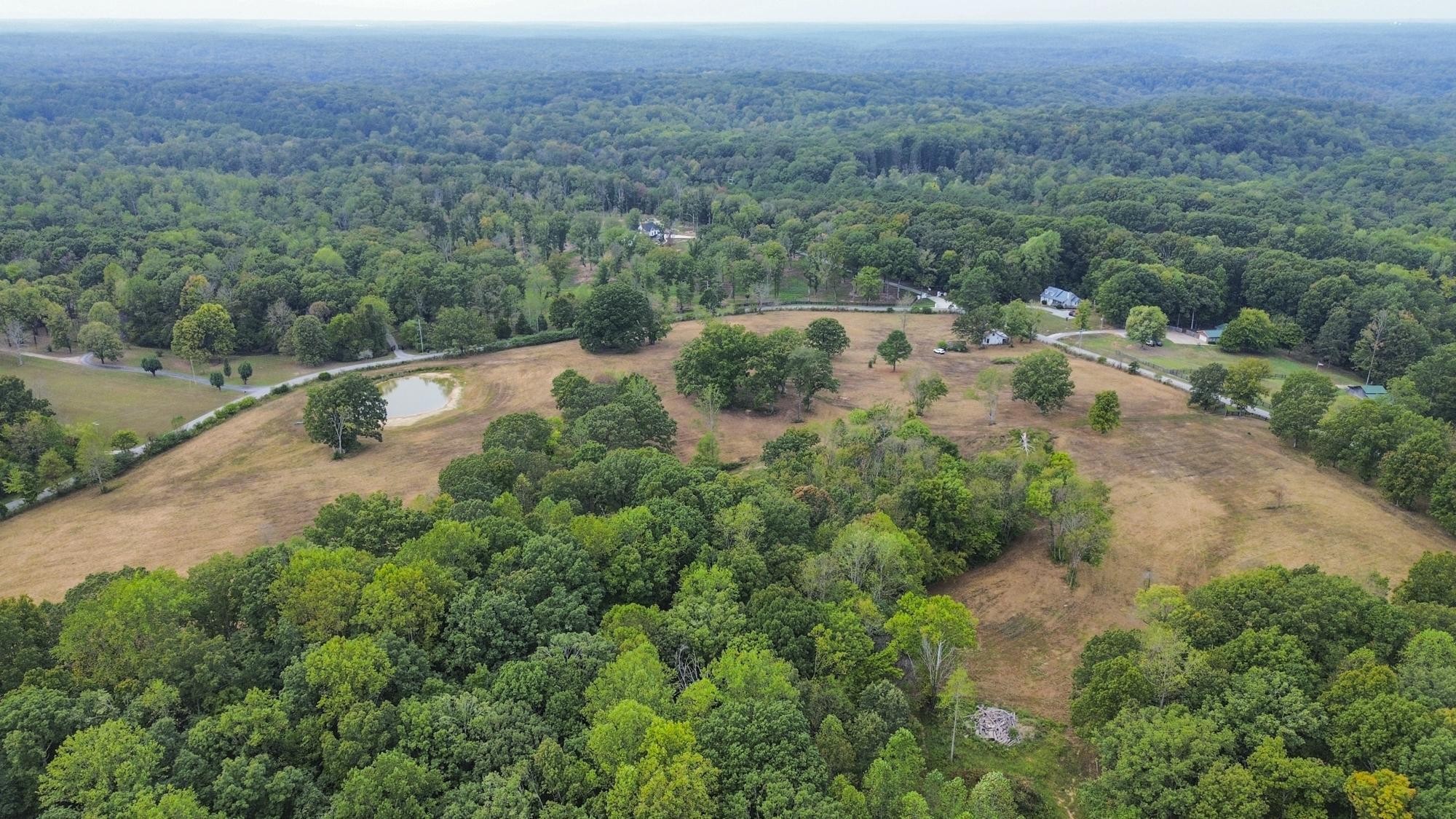1165 Mt Pleasant Road Kingston Springs, TN 37082 - Photo 5 of 7 an aerial view of residential house with outdoor space and trees all around