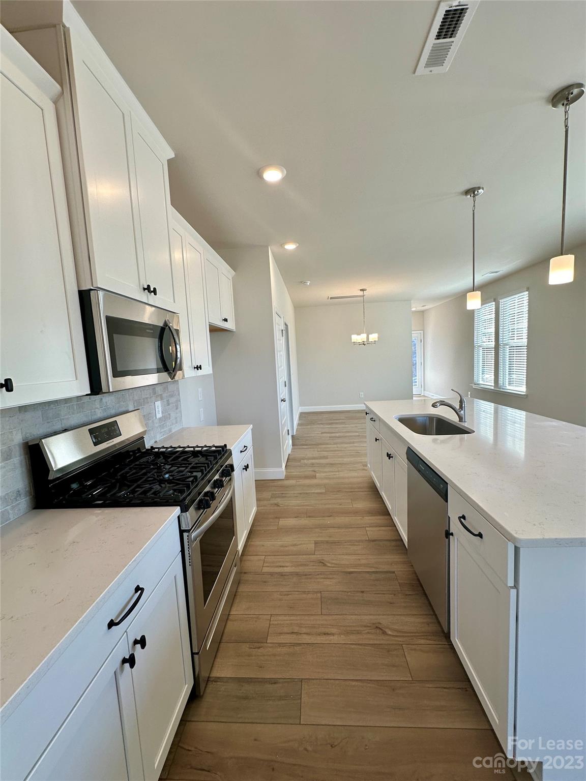 9519 Pointer Road Huntersville, NC 28078 - Photo 6 of 34 a large kitchen with stainless steel appliances a sink and a stove