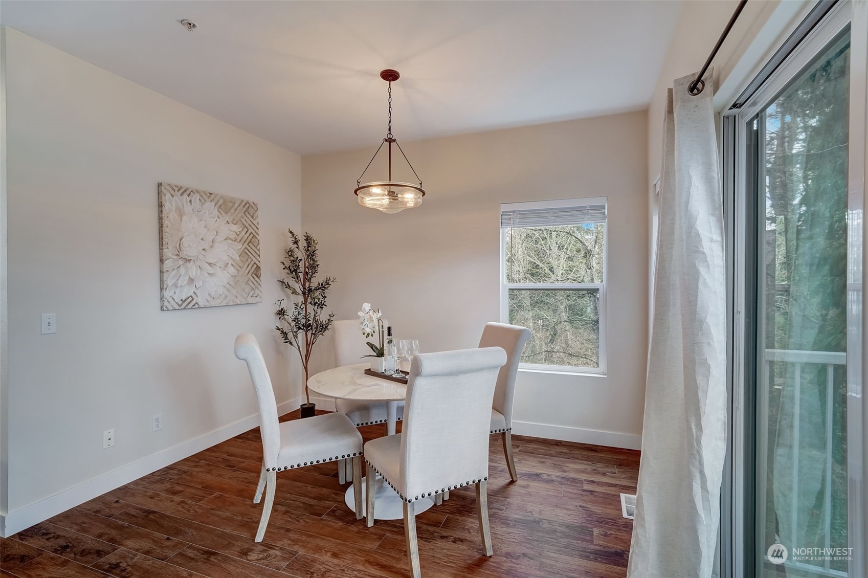 11873 Northeast 162nd Lane, Unit 121 Bothell, WA 98011 - Photo 11 of 32 a view of a dining room with furniture wooden floor and chandelier