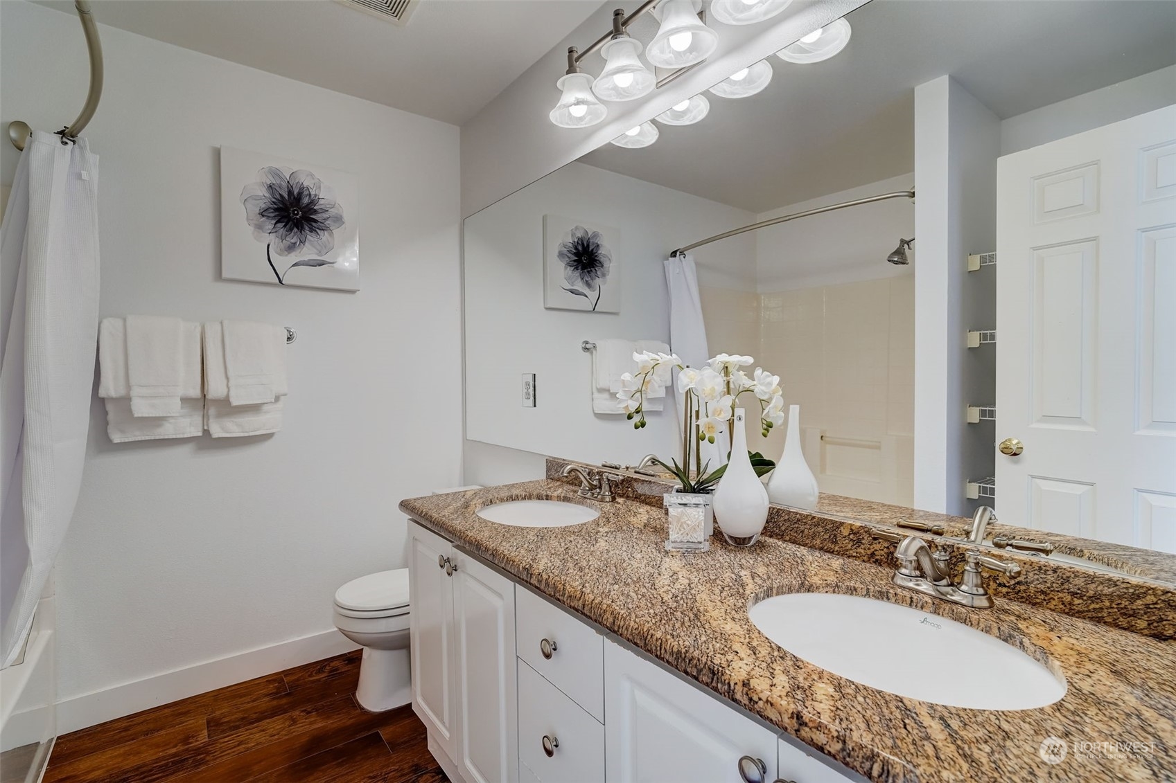 11873 Northeast 162nd Lane, Unit 121 Bothell, WA 98011 - Photo 18 of 32 a bathroom with a granite countertop sink a toilet and a mirror