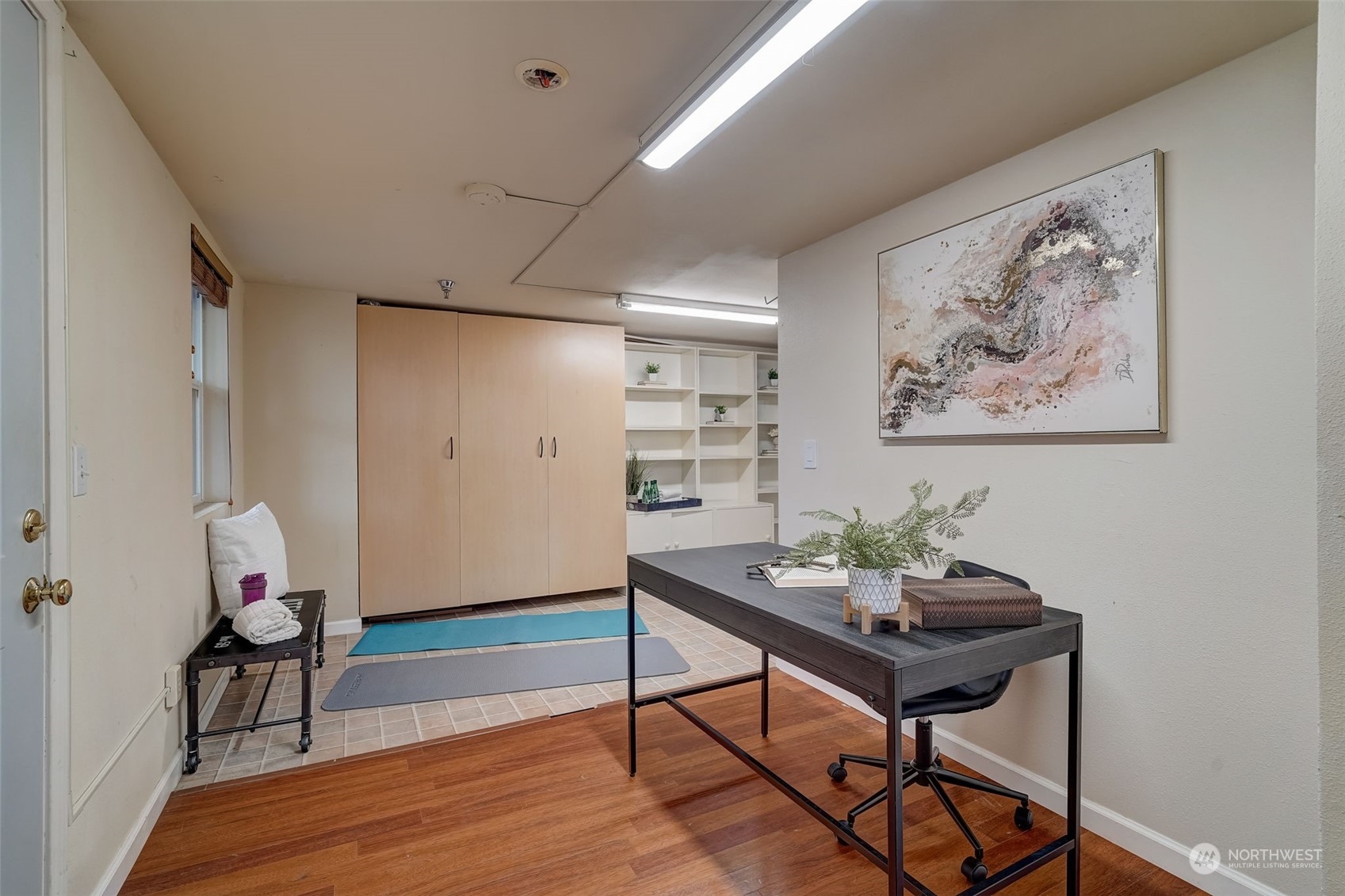 11873 Northeast 162nd Lane, Unit 121 Bothell, WA 98011 - Photo 25 of 32 a view of a workspace room with wooden floor and a bookshelf