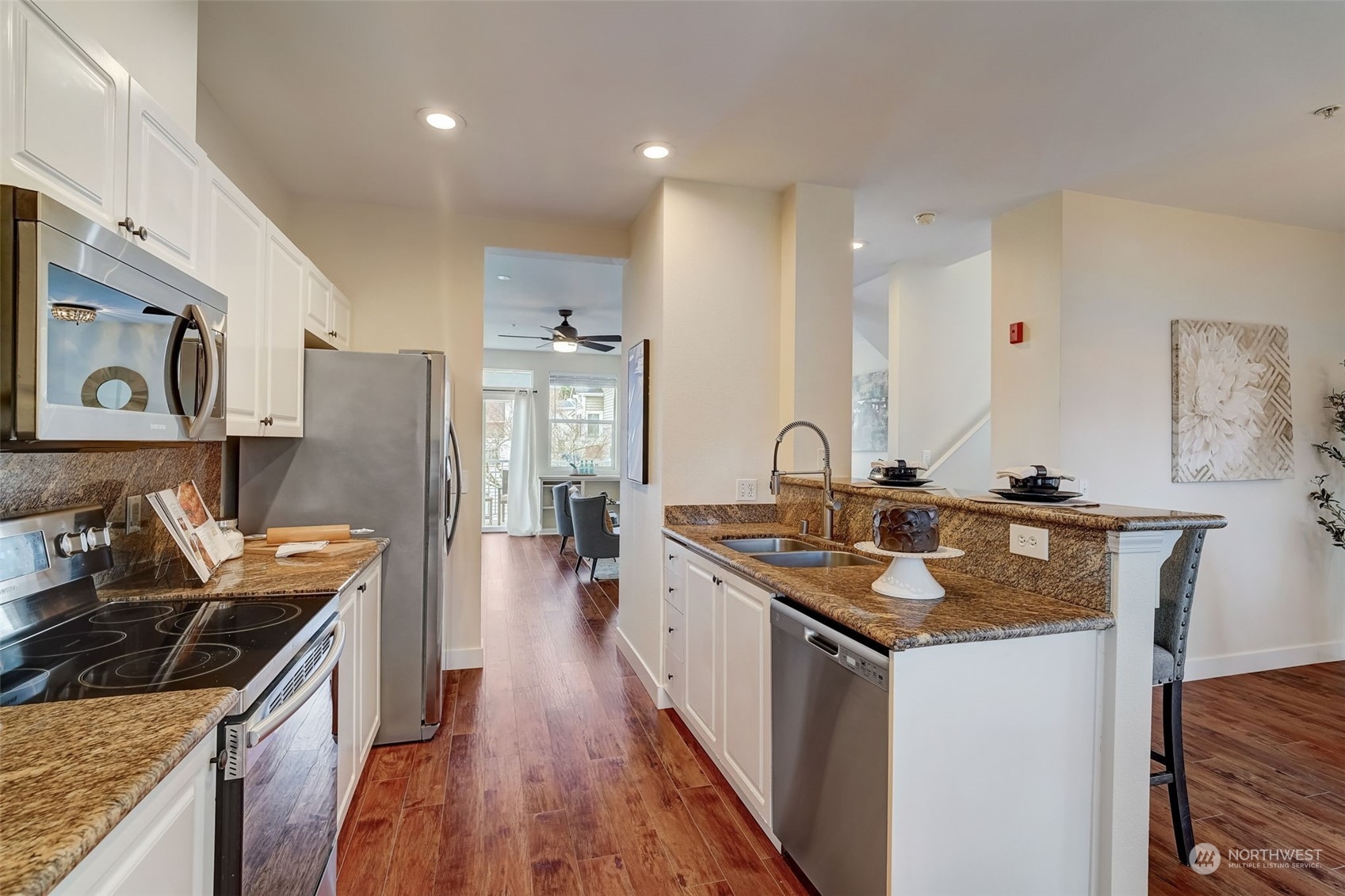11873 Northeast 162nd Lane, Unit 121 Bothell, WA 98011 - Photo 6 of 32 a kitchen with stainless steel appliances granite countertop a stove a sink dishwasher and a refrigerator