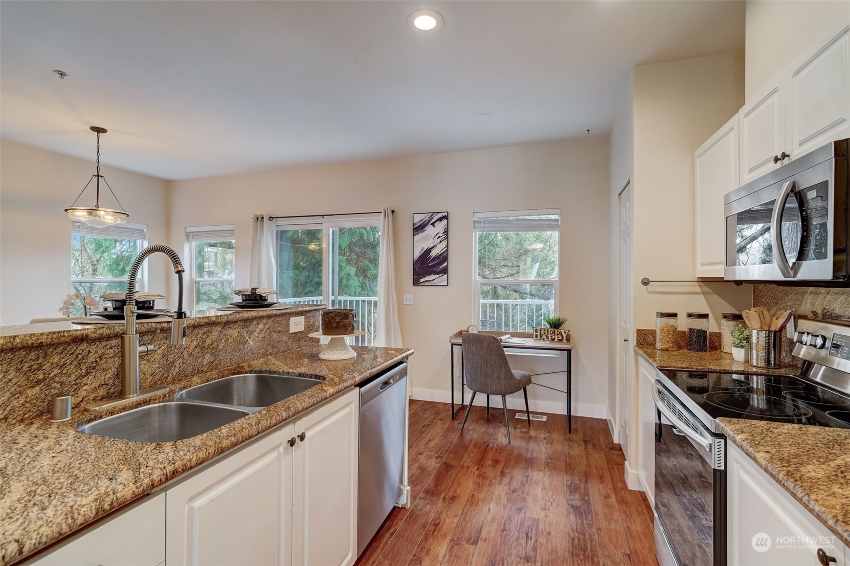 11873 Northeast 162nd Lane, Unit 121 Bothell, WA 98011 - Photo 7 of 32 a kitchen that has a sink a stove and wooden floors