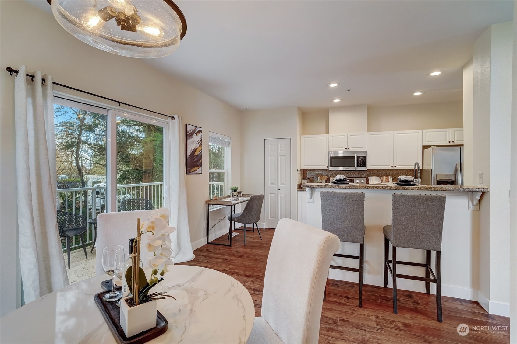 11873 Northeast 162nd Lane, Unit 121 Bothell, WA 98011 - Photo 9 of 32 a dining room with furniture a window and wooden floor