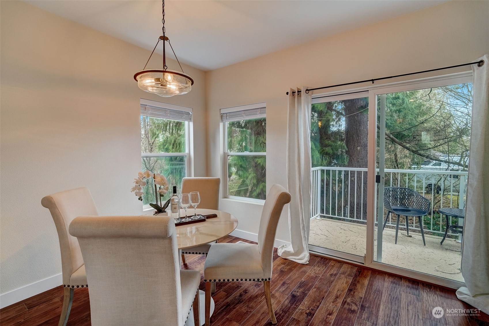 11873 Northeast 162nd Lane, Unit 121 Bothell, WA 98011 - Photo 10 of 32 a view of a dining room with furniture wooden floor and front door