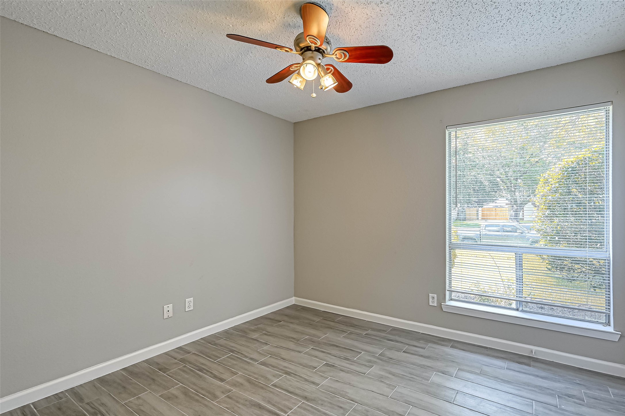 22622 John Rolfe Lane Katy, TX 77449 - Photo 12 of 21 wooden floor in an empty room with a window