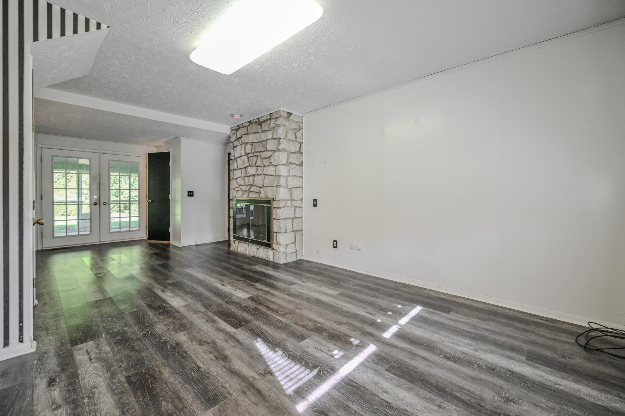 2807 Rensselaer Street Springfield, OH 45503 - Photo 35 of 49 Wide open room complimented by a stone faced fireplace as the focal point in the room.