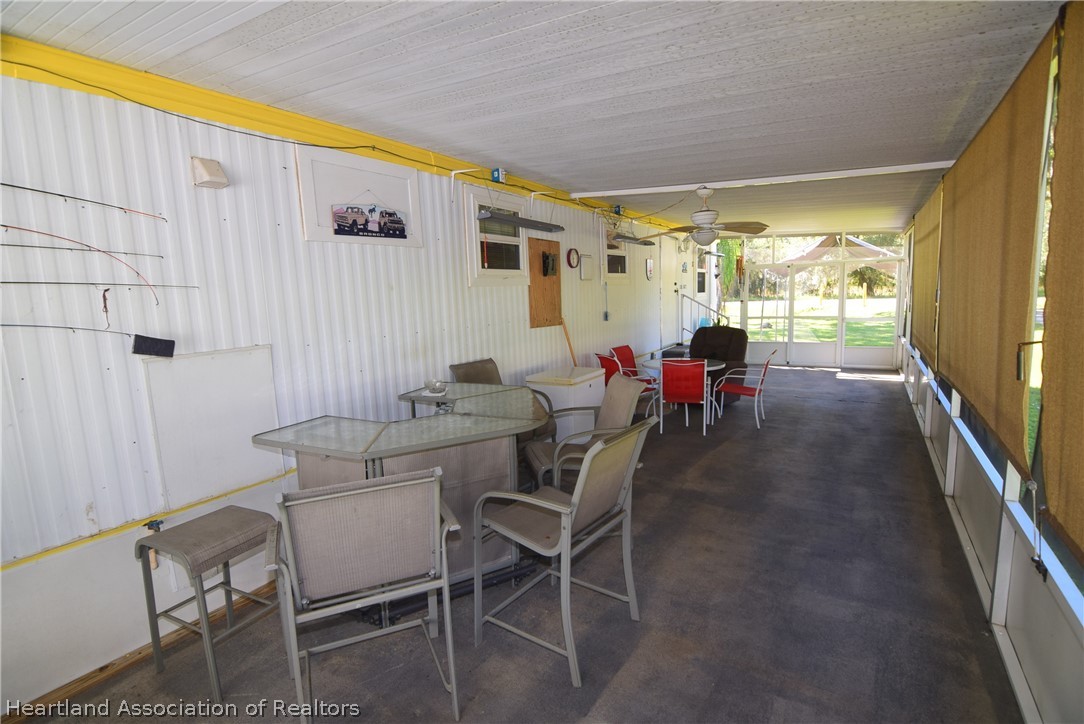 14 Henderson Road Lake Placid, FL 33852 - Photo 11 of 28 a dining room with furniture and a floor to ceiling window