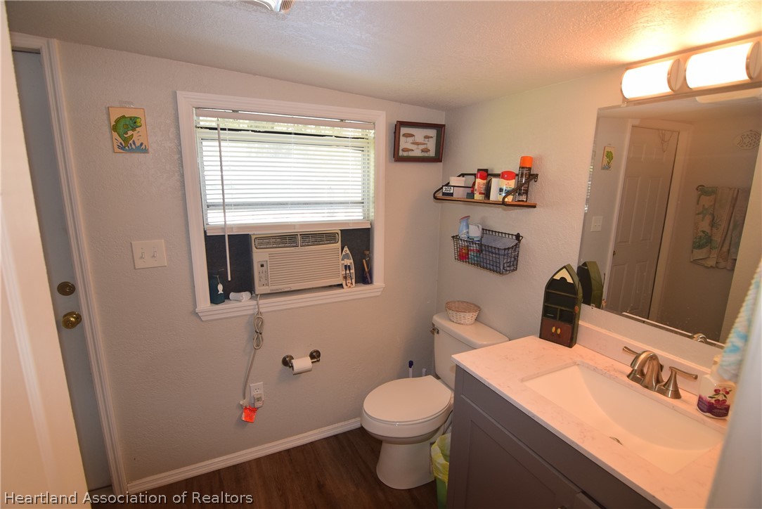 14 Henderson Road Lake Placid, FL 33852 - Photo 23 of 28 a bathroom with a sink a toilet and a mirror