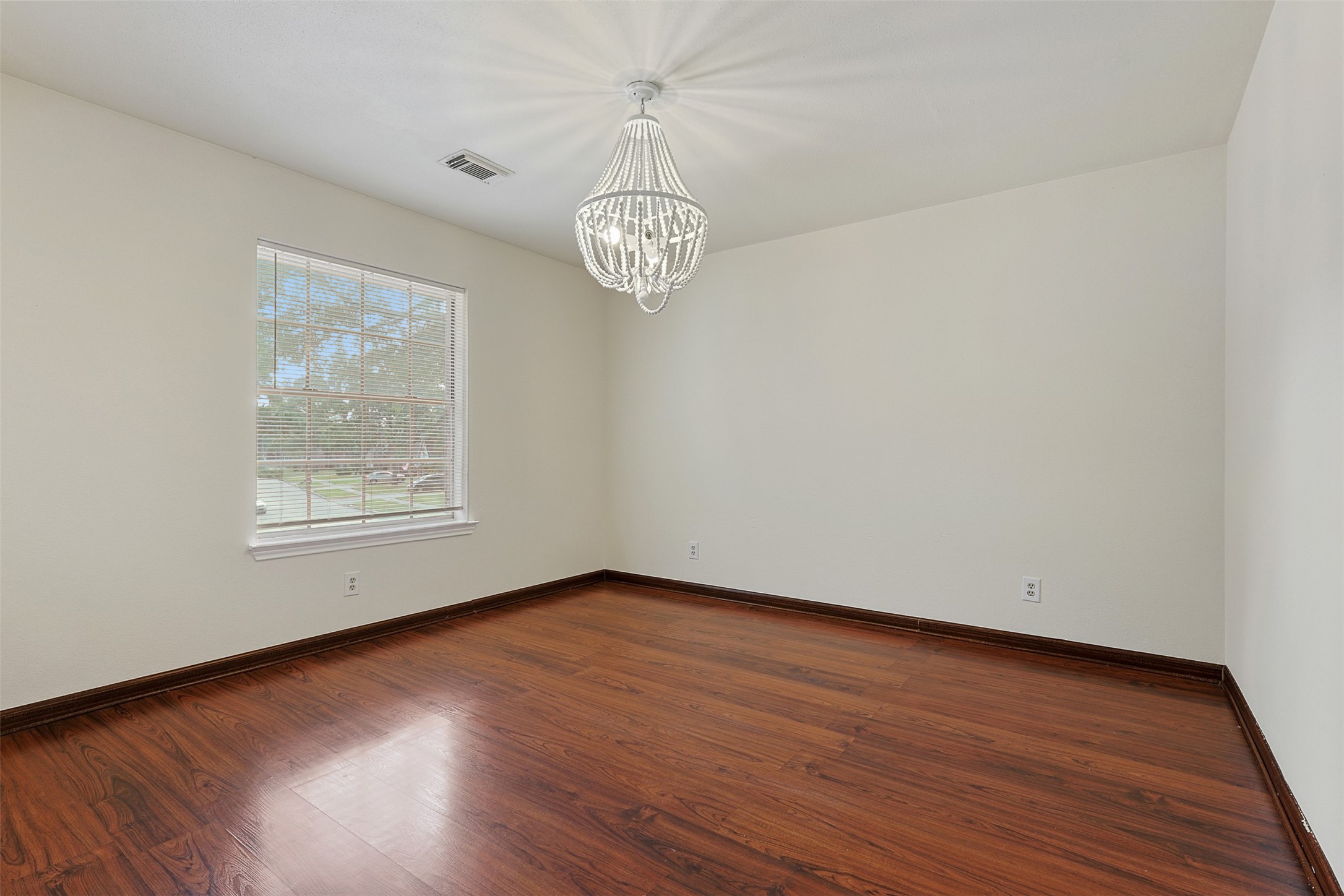 9414 Calwood Circle Spring, TX 77379 - Photo 12 of 17 a view of an empty room with wooden floor and a window