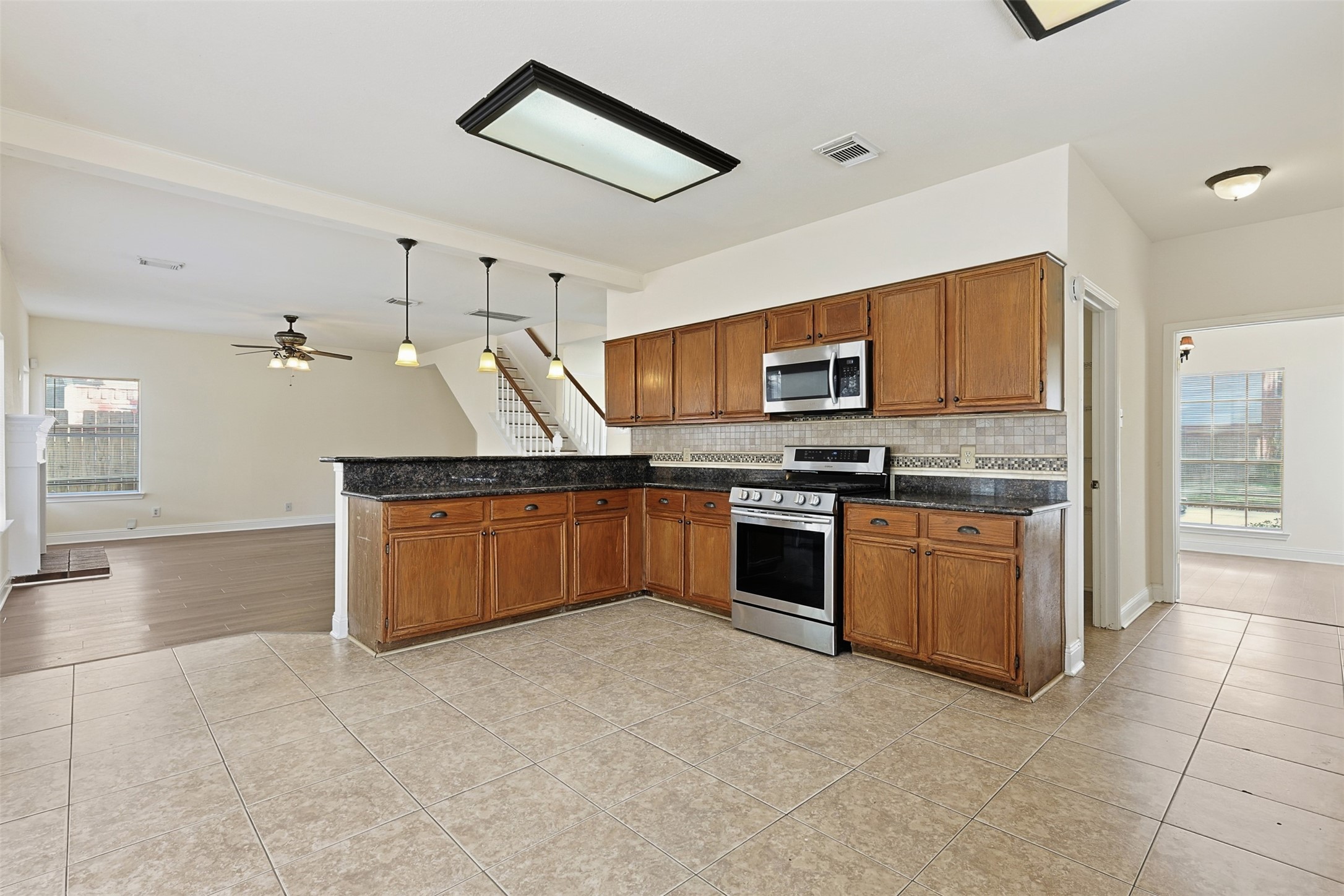 9414 Calwood Circle Spring, TX 77379 - Photo 6 of 17 a kitchen with granite countertop a stove and cabinets