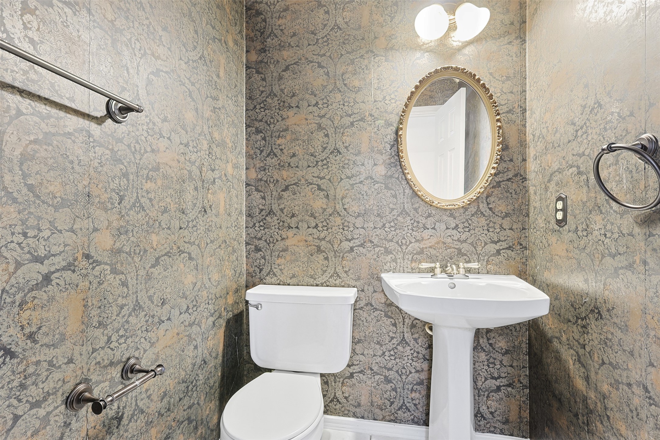 9414 Calwood Circle Spring, TX 77379 - Photo 9 of 17 a bathroom with a sink a mirror and a toilet