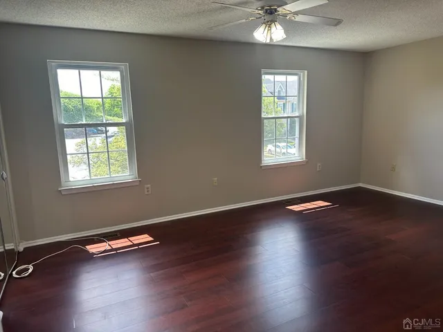 a view of a room with wooden floor and window
