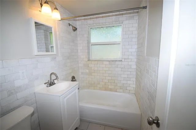 a view of a house with a yard and trees