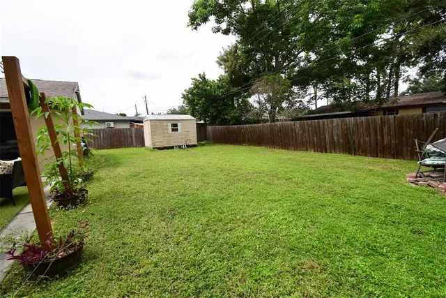 a view of a backyard with a table and chairs