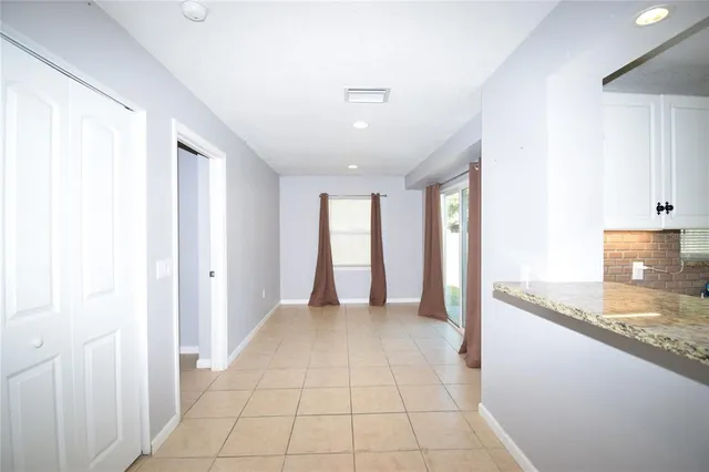 a kitchen with stainless steel appliances granite countertop a sink refrigerator and cabinets