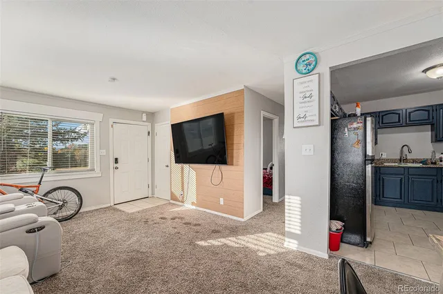 a view of a livingroom with furniture and floor to ceiling window