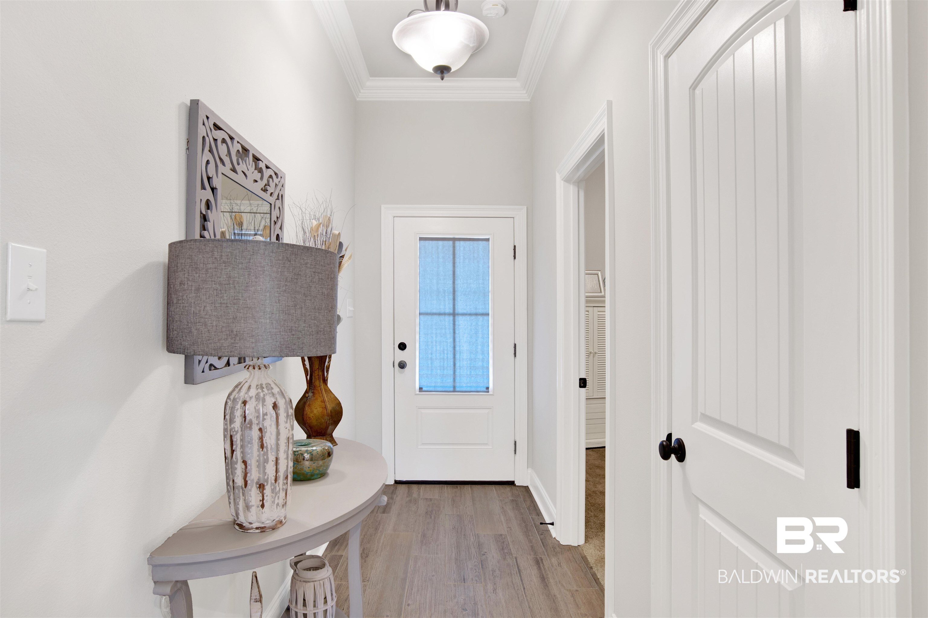 1406 Aldon Street Foley, AL 36535 - Photo 16 of 30 Doorway to outside with luxury wood-like tile flooring and ornamental molding