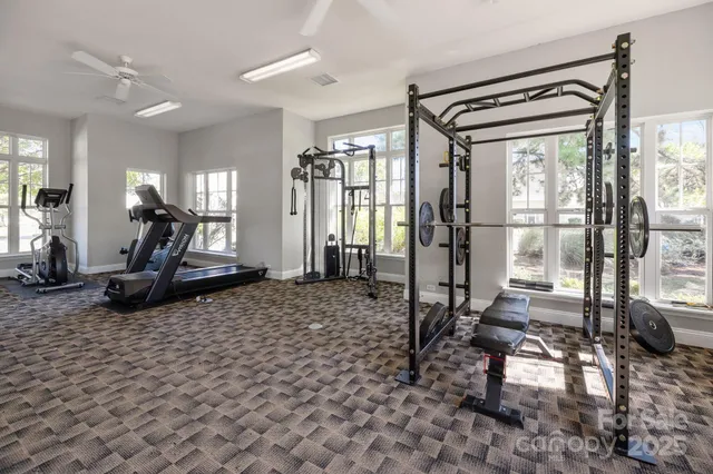 a living room with furniture a window and a chandelier
