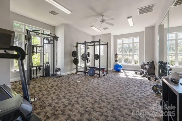 a living room with furniture a flat screen tv and a window
