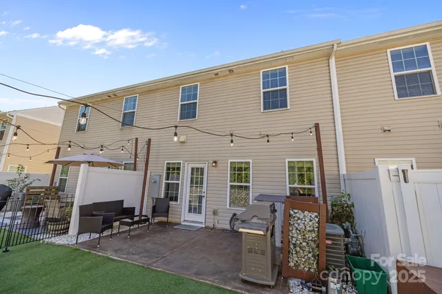 a backyard of a house with table and chairs