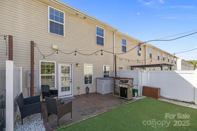 a view of a house with couches chairs and a yard