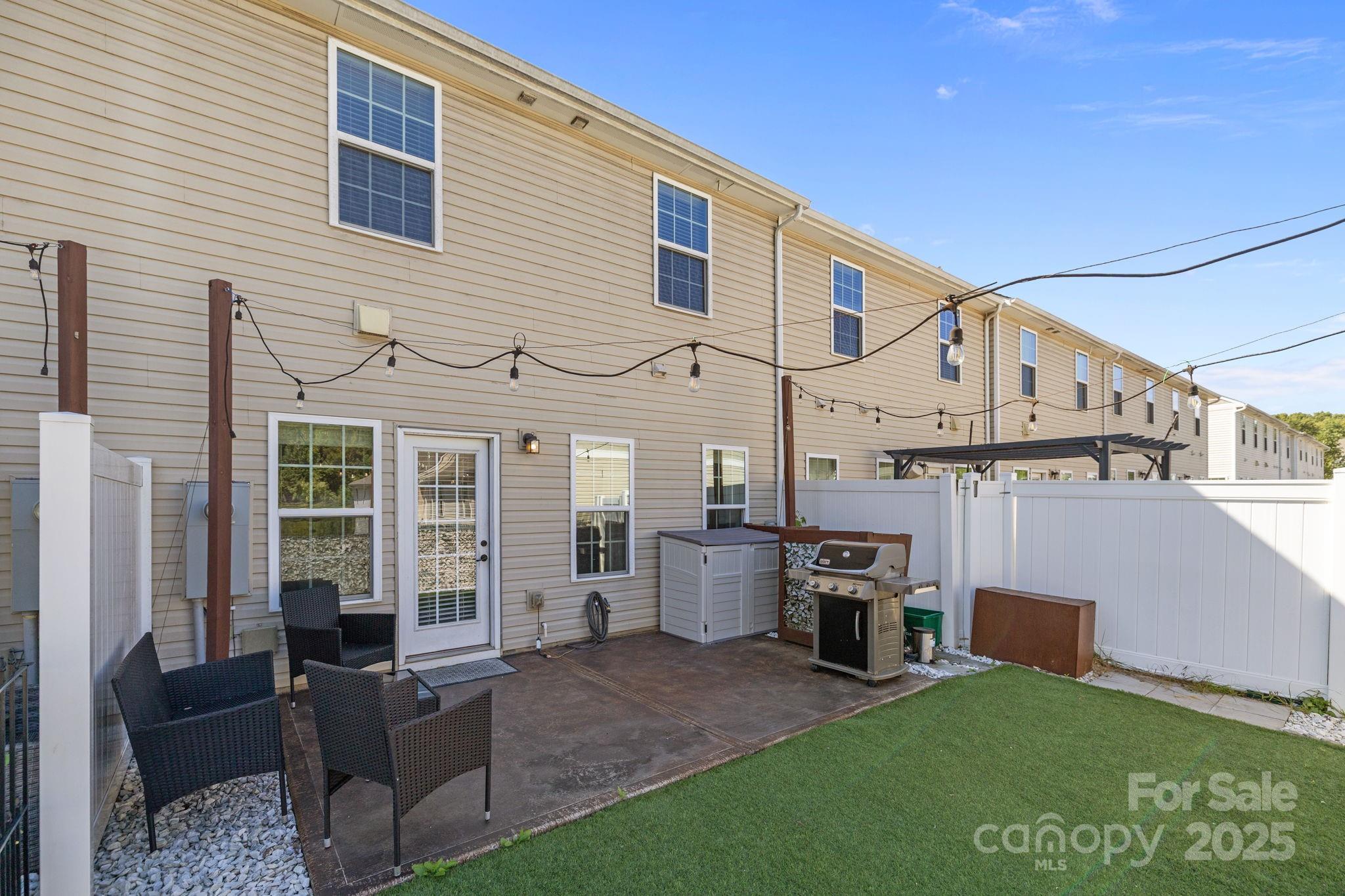 7443 Red Mulberry Way Charlotte, NC 28273 - Photo 19 of 45 a view of a house with couches chairs and a yard