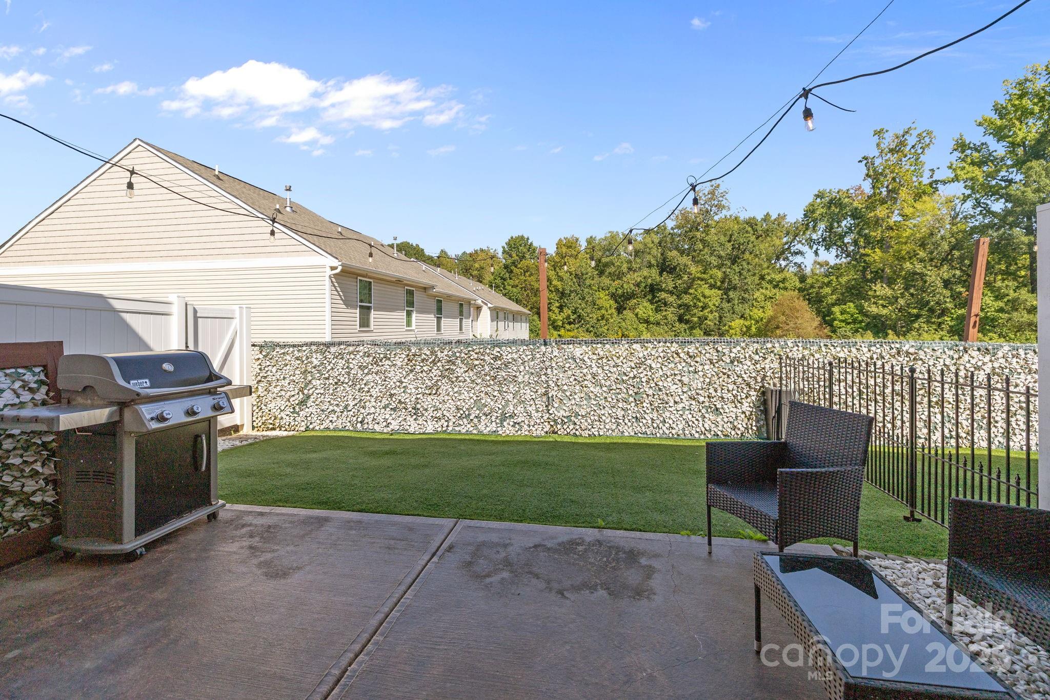 7443 Red Mulberry Way Charlotte, NC 28273 - Photo 21 of 45 a backyard of a house with table and chairs