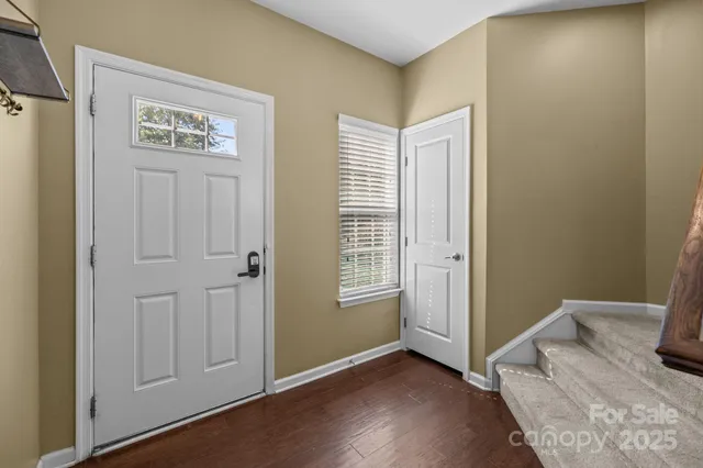 a view of a bedroom with wooden floor and closet