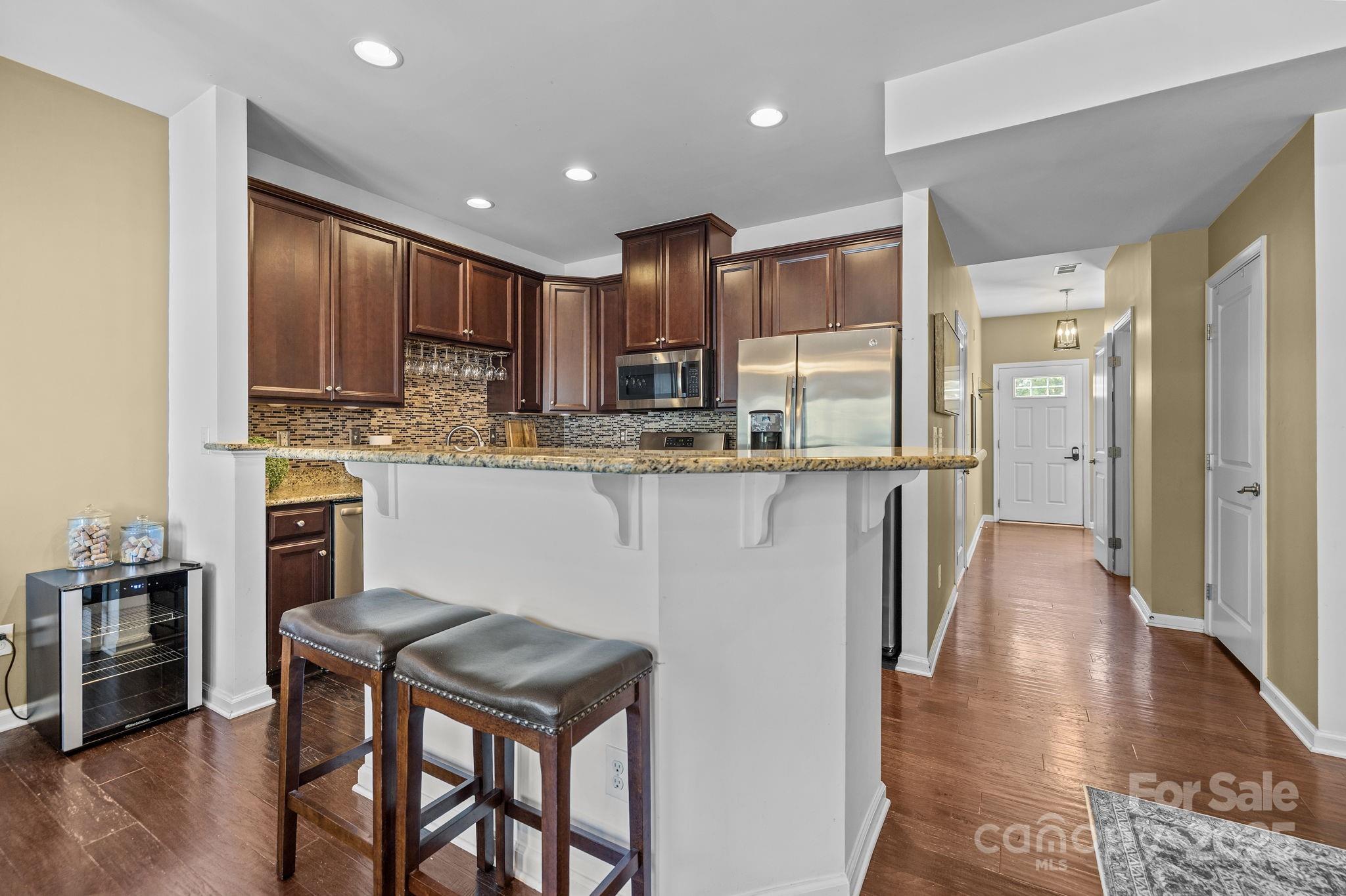 7443 Red Mulberry Way Charlotte, NC 28273 - Photo 24 of 45 a kitchen with stainless steel appliances granite countertop a stove top oven a sink and a refrigerator